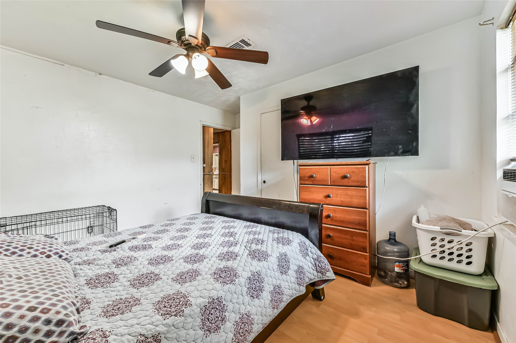 10438 Caxton Street Houston, TX 77016 - Photo 15 of 24 a bedroom with a bed and a flat screen tv