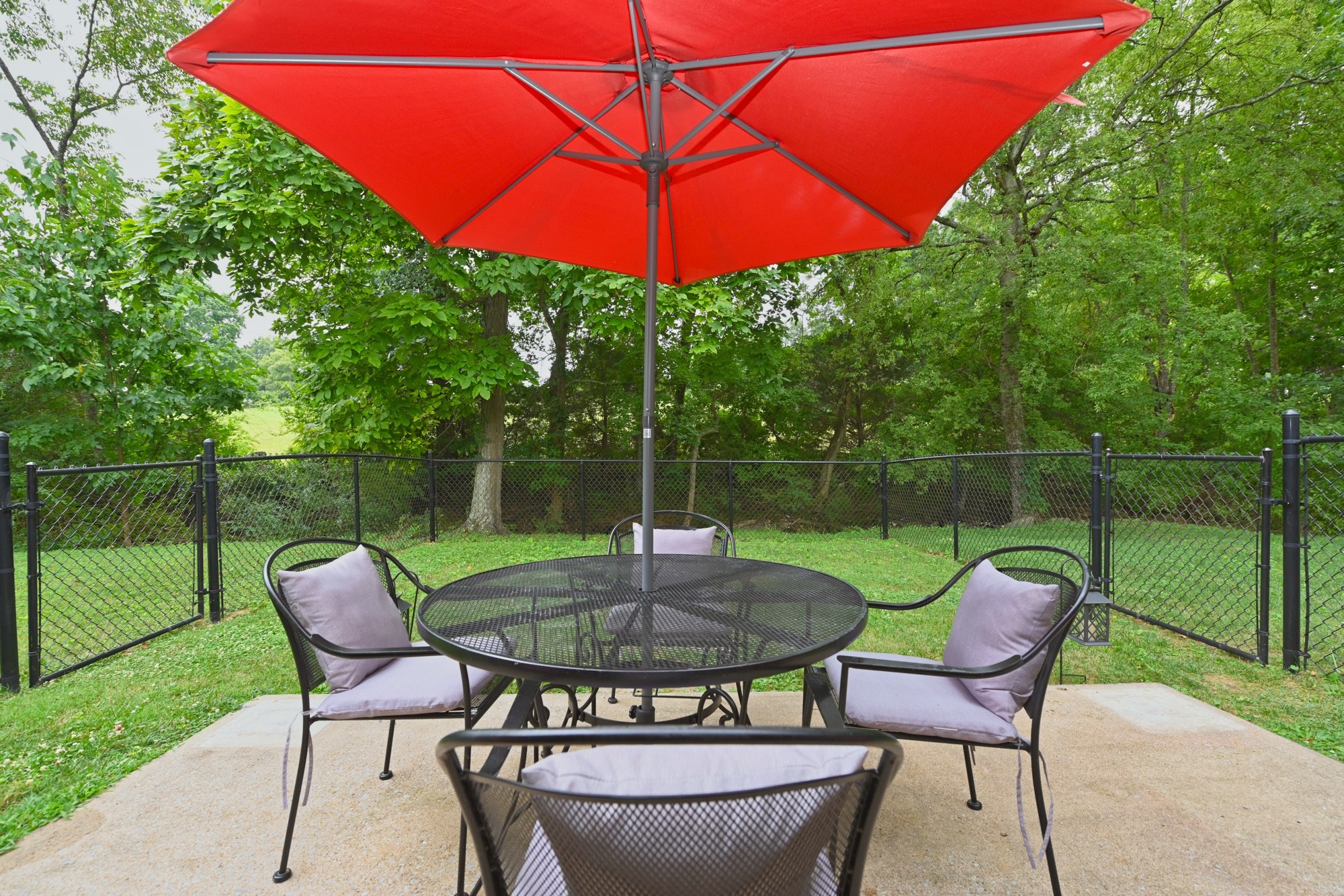 7809 Melton Road White House, TN 37188 - Photo 15 of 64 a patio with a table and chairs under an umbrella