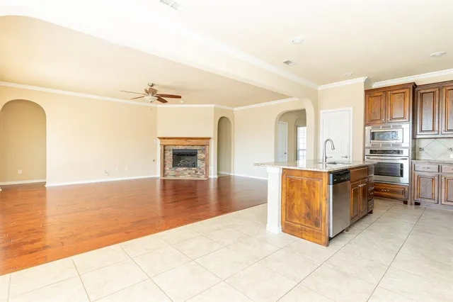 a view of a living room a kitchen with furniture and a fireplace