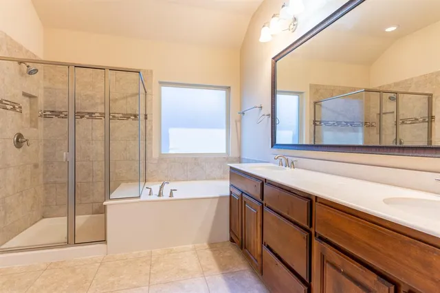 a spacious bathroom with a bathtub and a shower