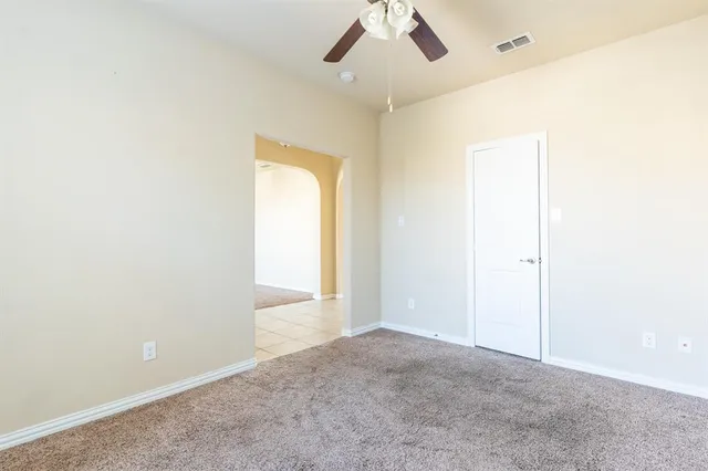 an empty room with a empty space and a ceiling fan
