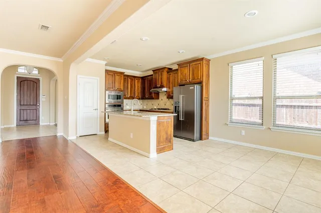 a kitchen with stainless steel appliances a refrigerator and a stove top oven