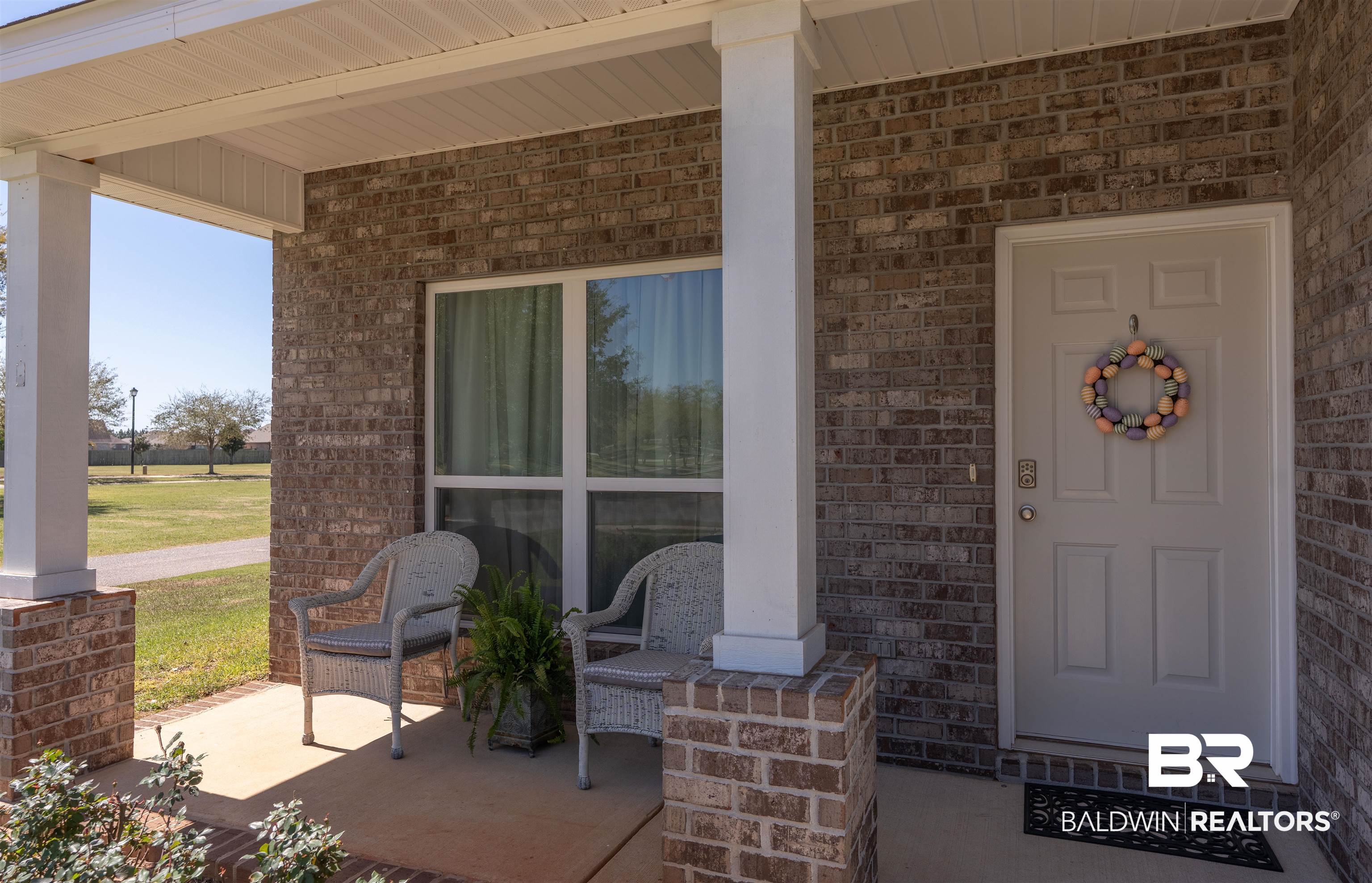23809 Devonfield Lane Daphne, AL 36526 - Photo 6 of 29 Property entrance with covered porch and brick siding