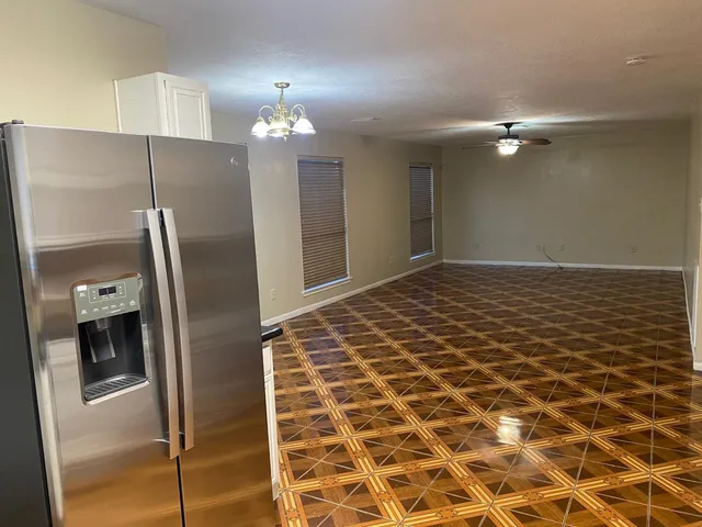 a kitchen with a sink and a refrigerator