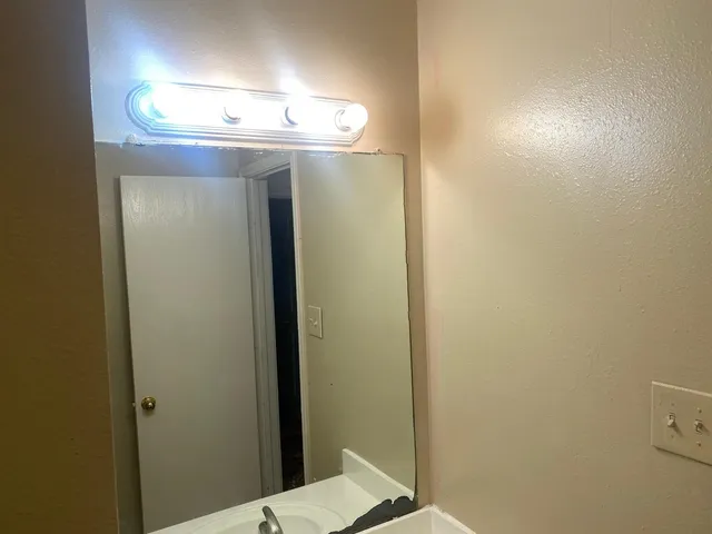 a kitchen with stainless steel appliances granite countertop a refrigerator a stove and a sink