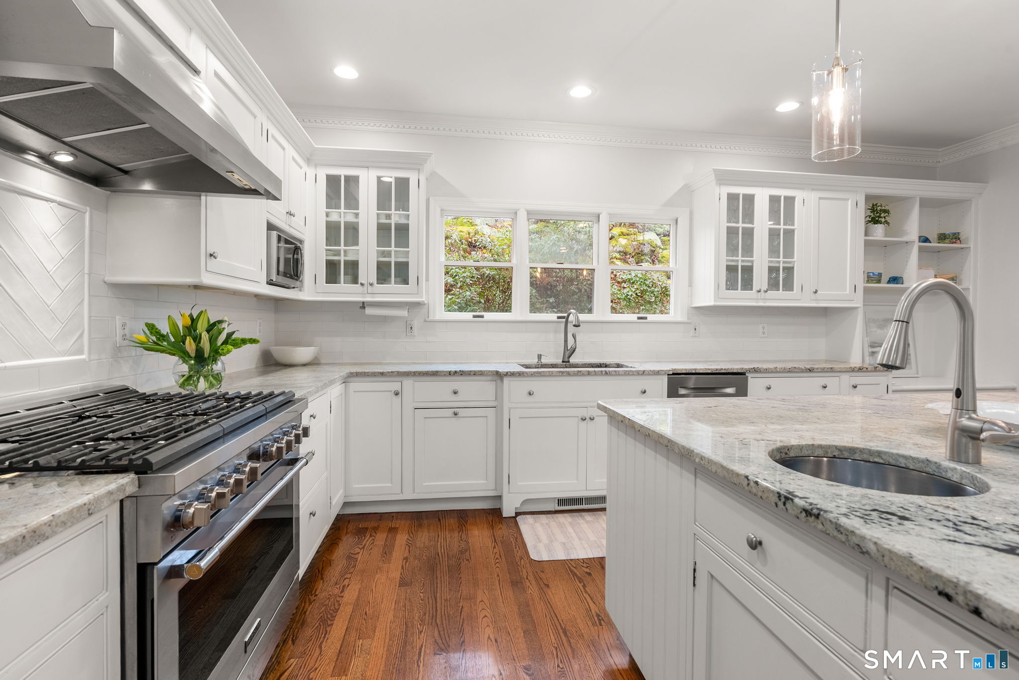 9 Pepperbush Road Weston, CT 06883 - Photo 11 of 48 a kitchen with a sink stove and cabinets