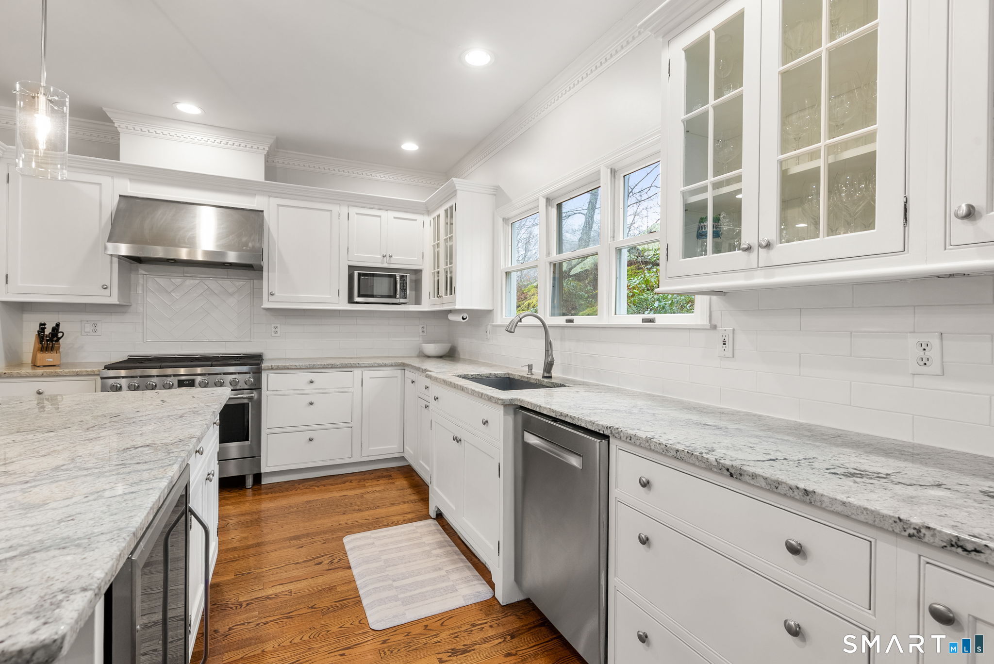 9 Pepperbush Road Weston, CT 06883 - Photo 14 of 48 a kitchen with stainless steel appliances granite countertop a sink and stove top oven