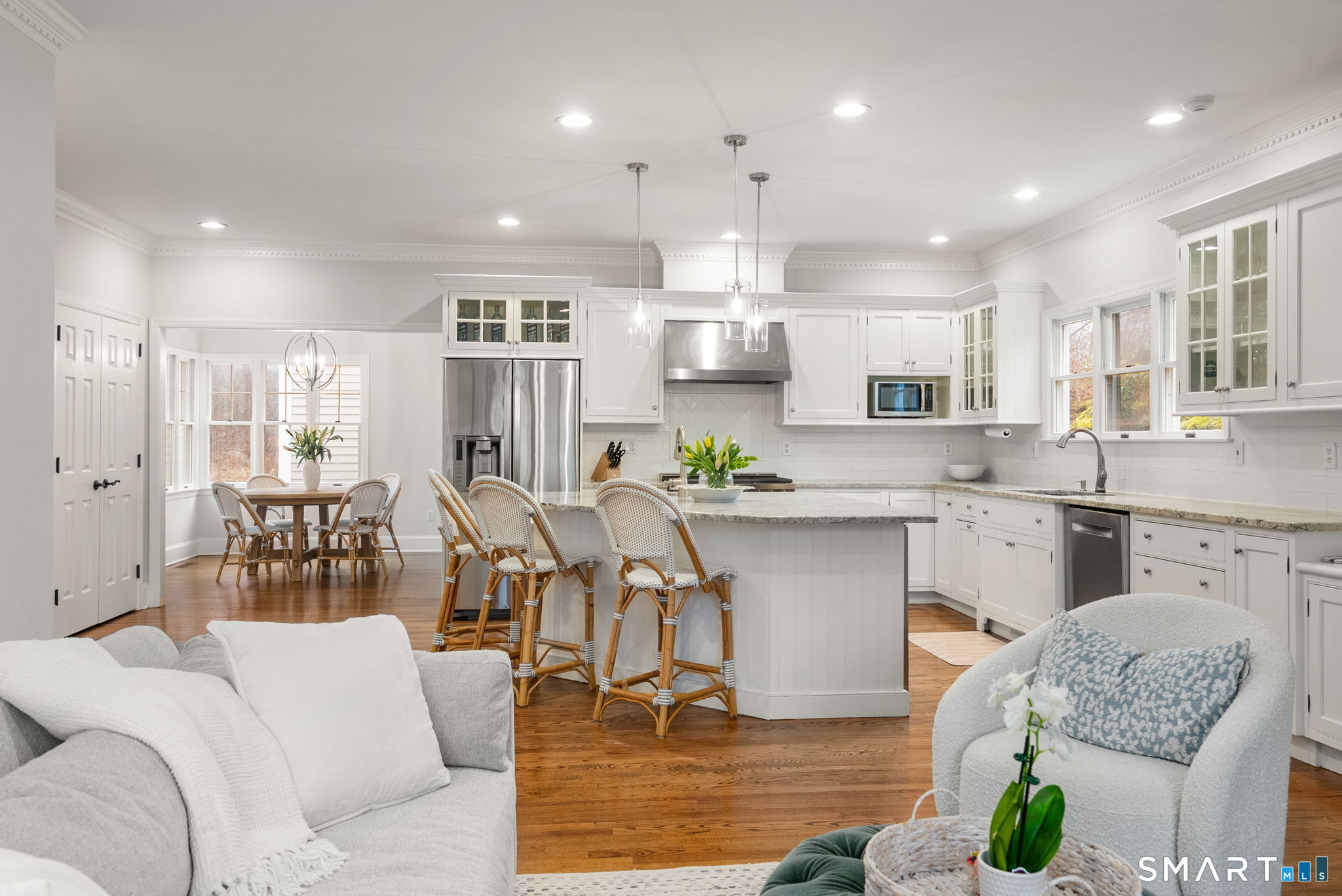 9 Pepperbush Road Weston, CT 06883 - Photo 2 of 48 a kitchen with stainless steel appliances granite countertop a refrigerator oven a sink dishwasher and white cabinets with wooden floor