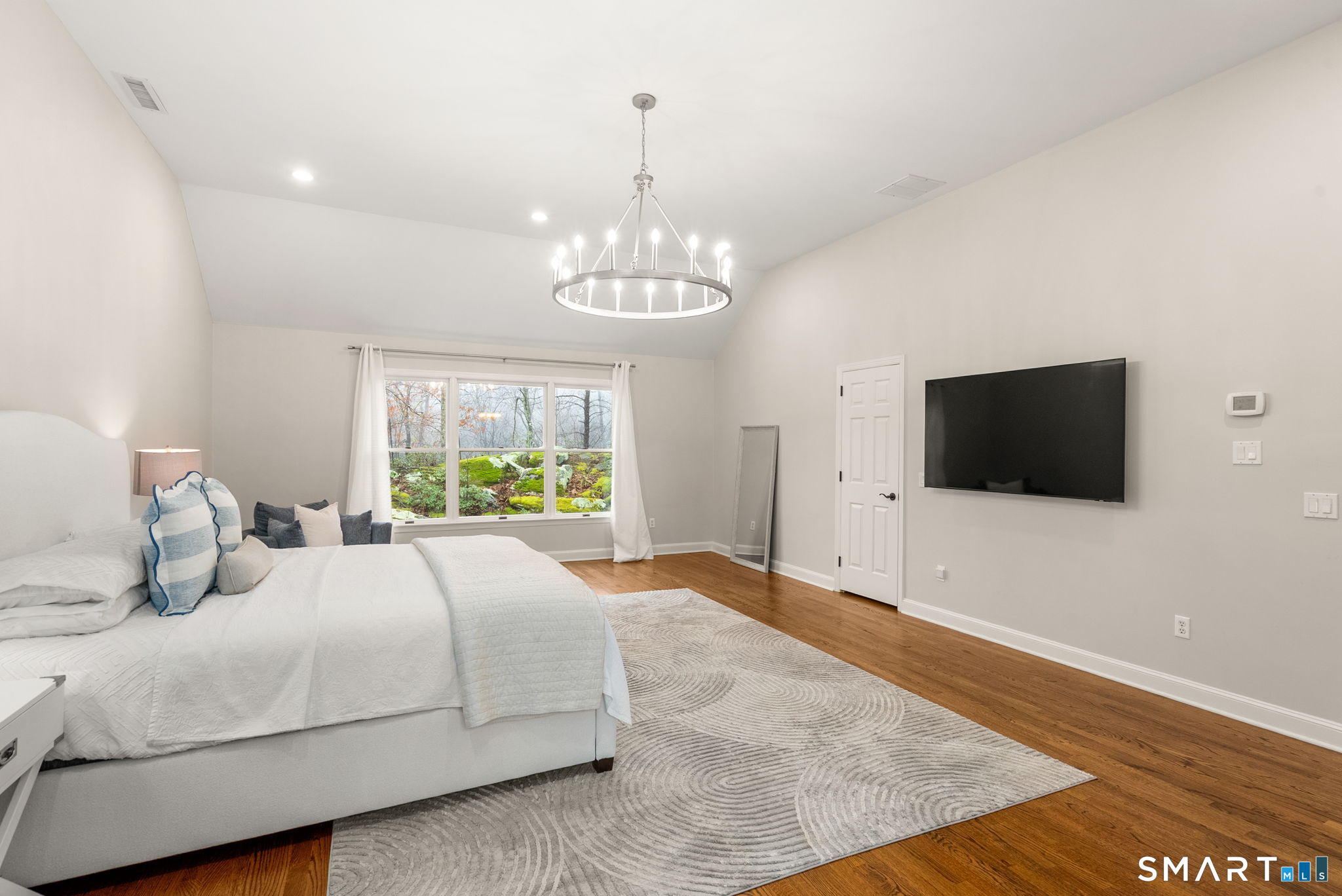 9 Pepperbush Road Weston, CT 06883 - Photo 21 of 48 a bedroom with a large bed and a flat screen tv