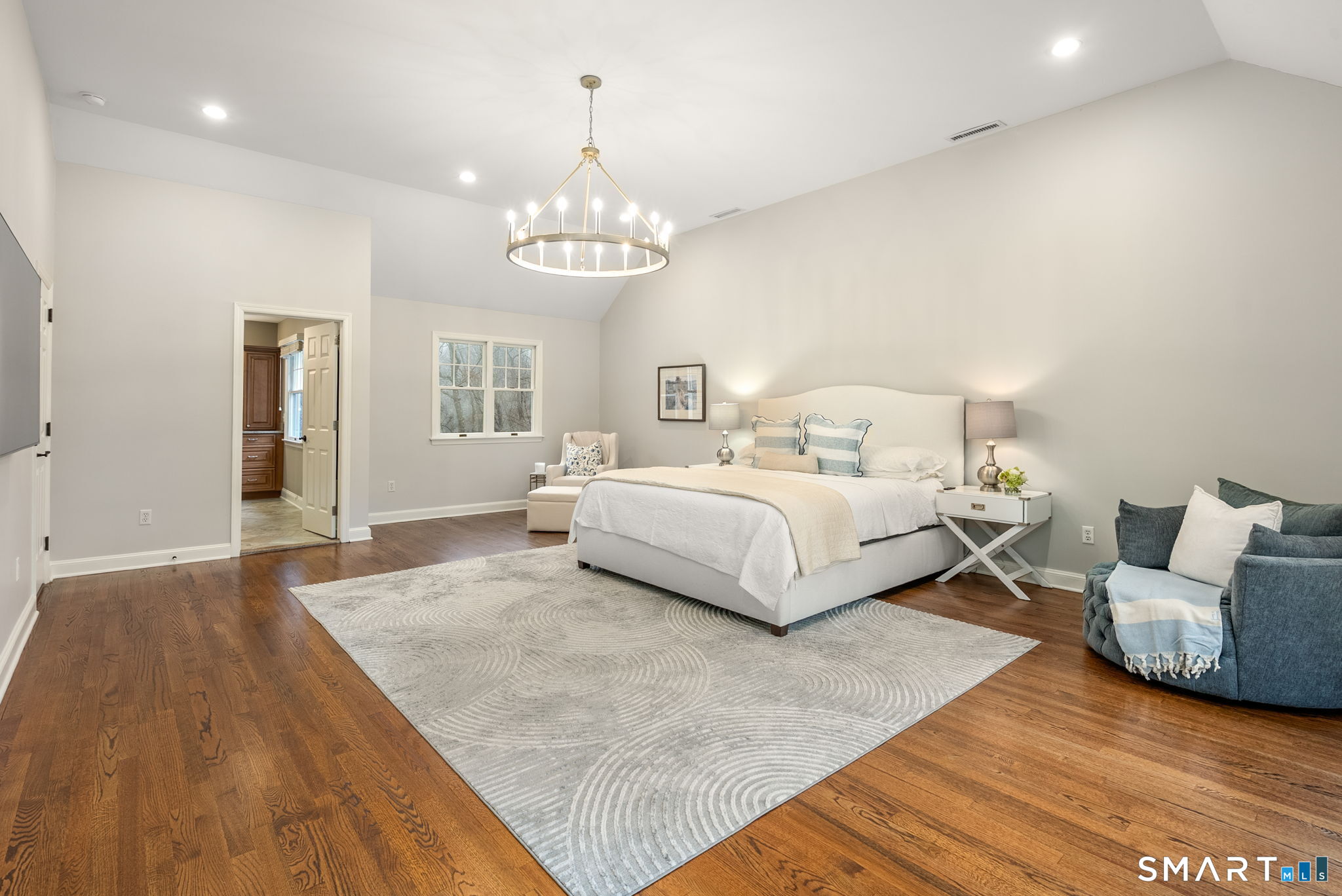 9 Pepperbush Road Weston, CT 06883 - Photo 28 of 48 a spacious bedroom with a bed and a chandelier