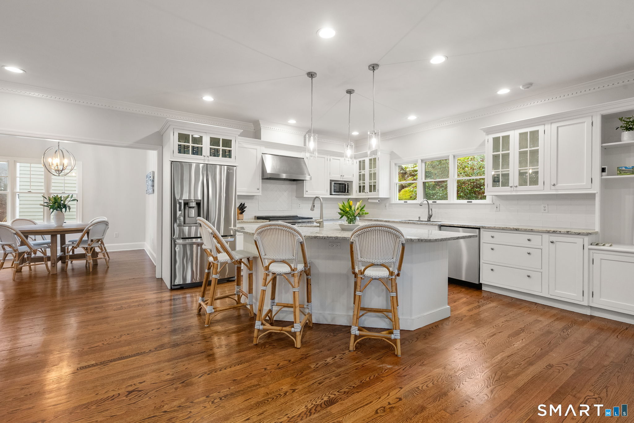 9 Pepperbush Road Weston, CT 06883 - Photo 3 of 48 a kitchen with stainless steel appliances a dining table chairs and wooden floor