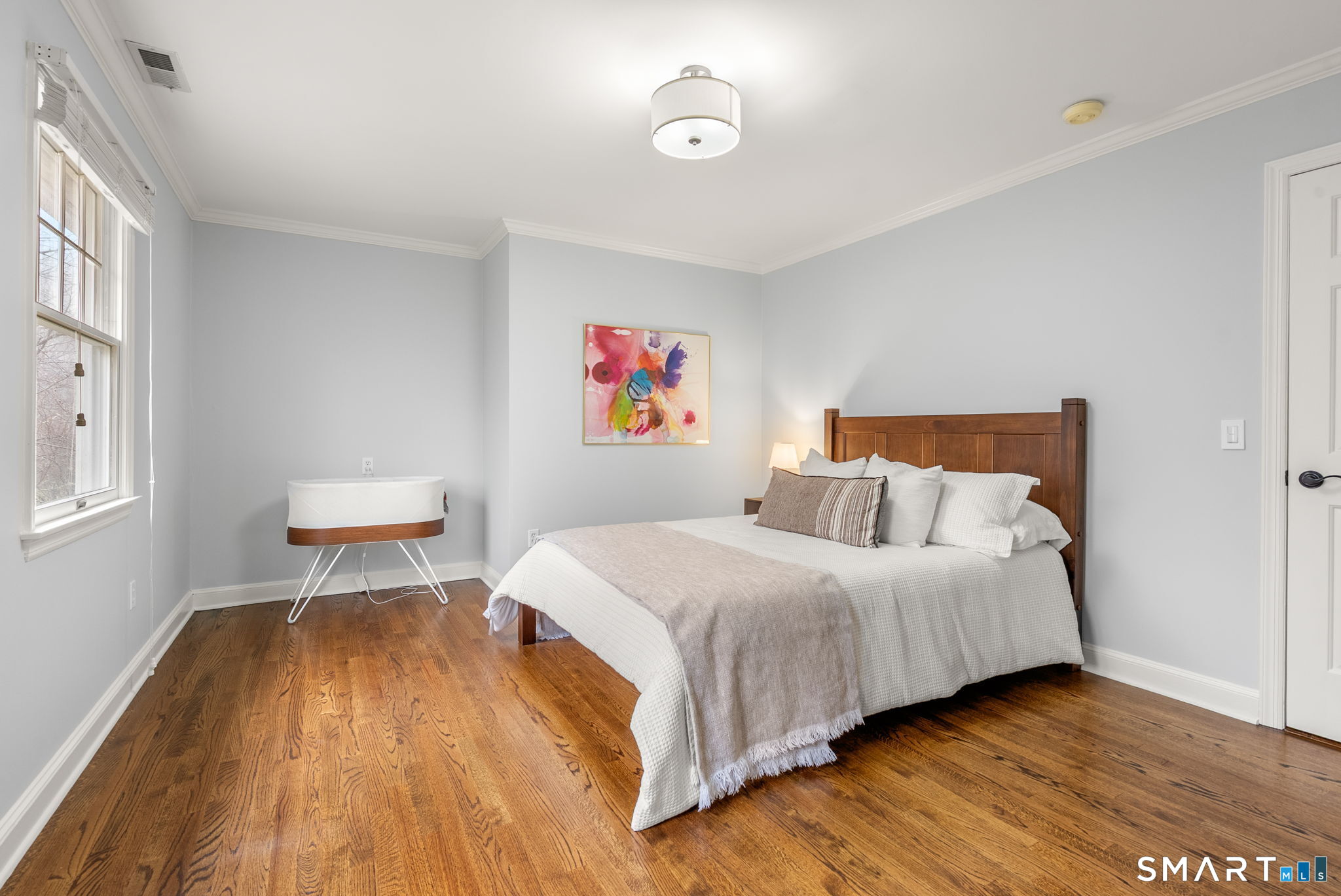 9 Pepperbush Road Weston, CT 06883 - Photo 35 of 48 a bedroom with a bed and wooden floor