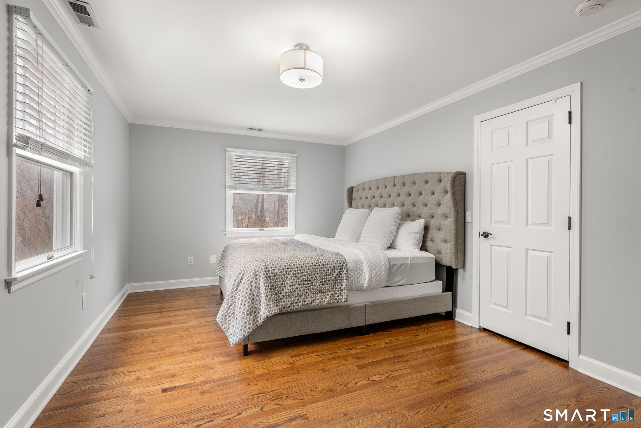 9 Pepperbush Road Weston, CT 06883 - Photo 36 of 48 a bedroom with a bed and wooden floor