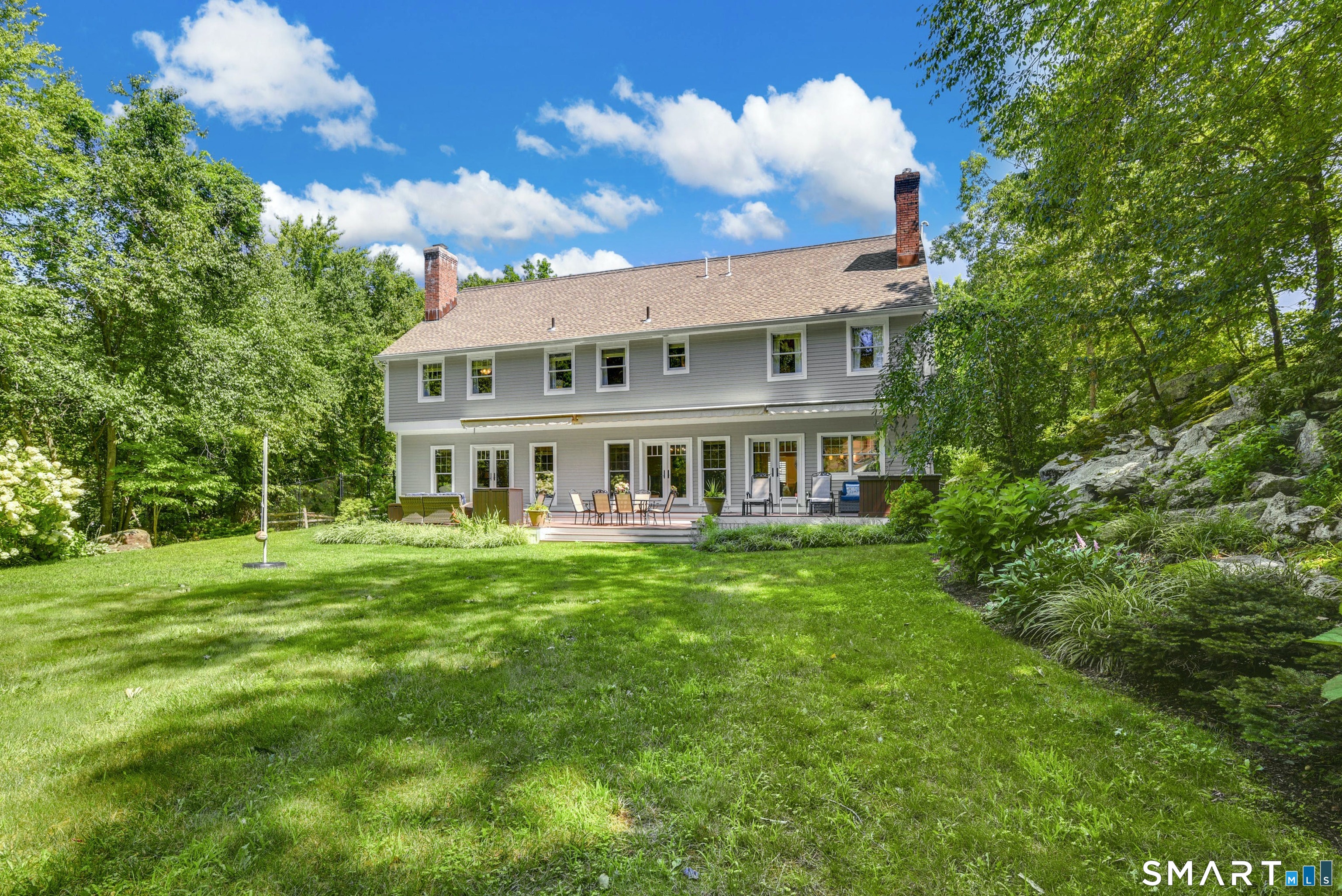 9 Pepperbush Road Weston, CT 06883 - Photo 45 of 48 a view of a house with a big yard potted plants and large tree