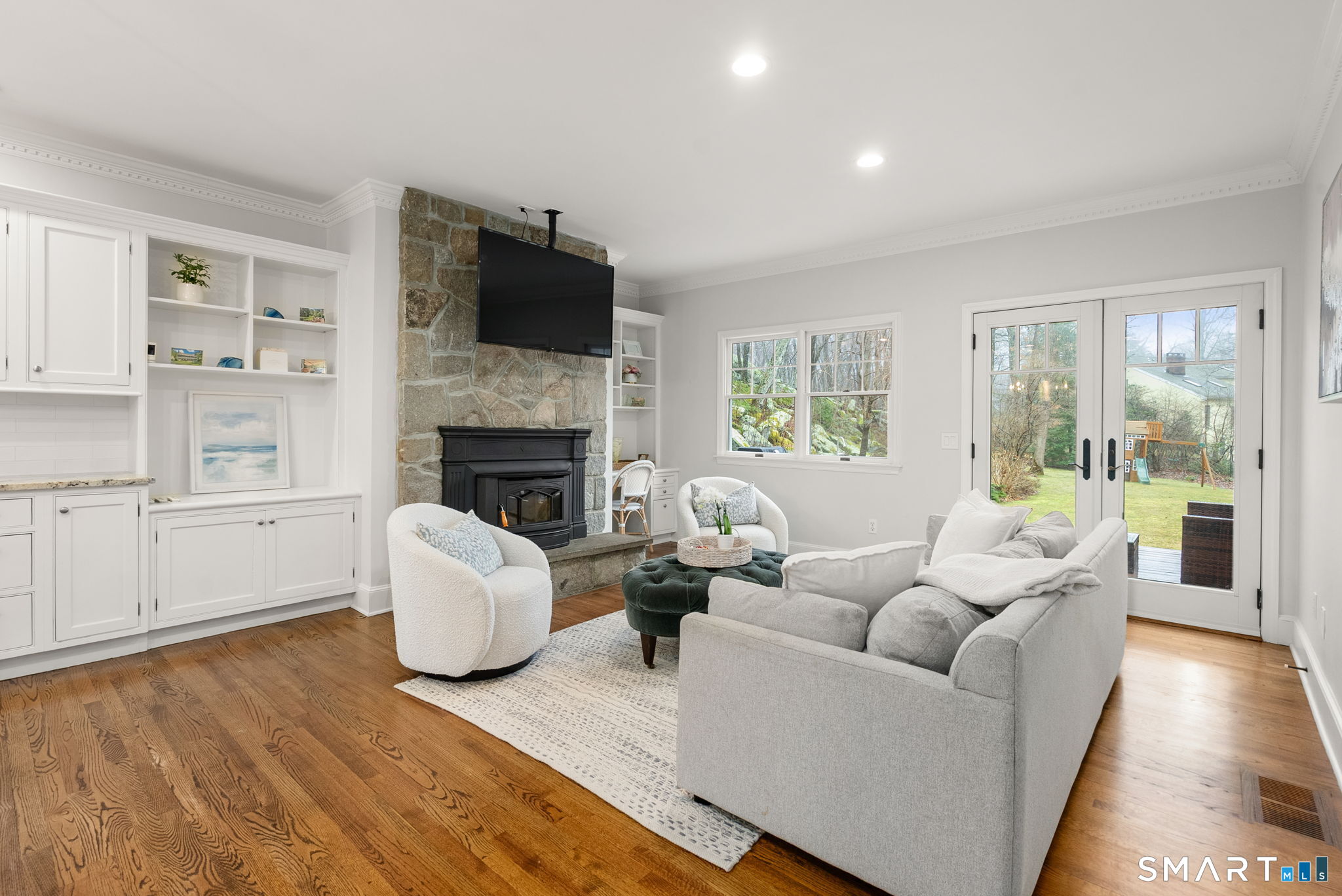 9 Pepperbush Road Weston, CT 06883 - Photo 7 of 48 a living room with fireplace furniture and a flat screen tv