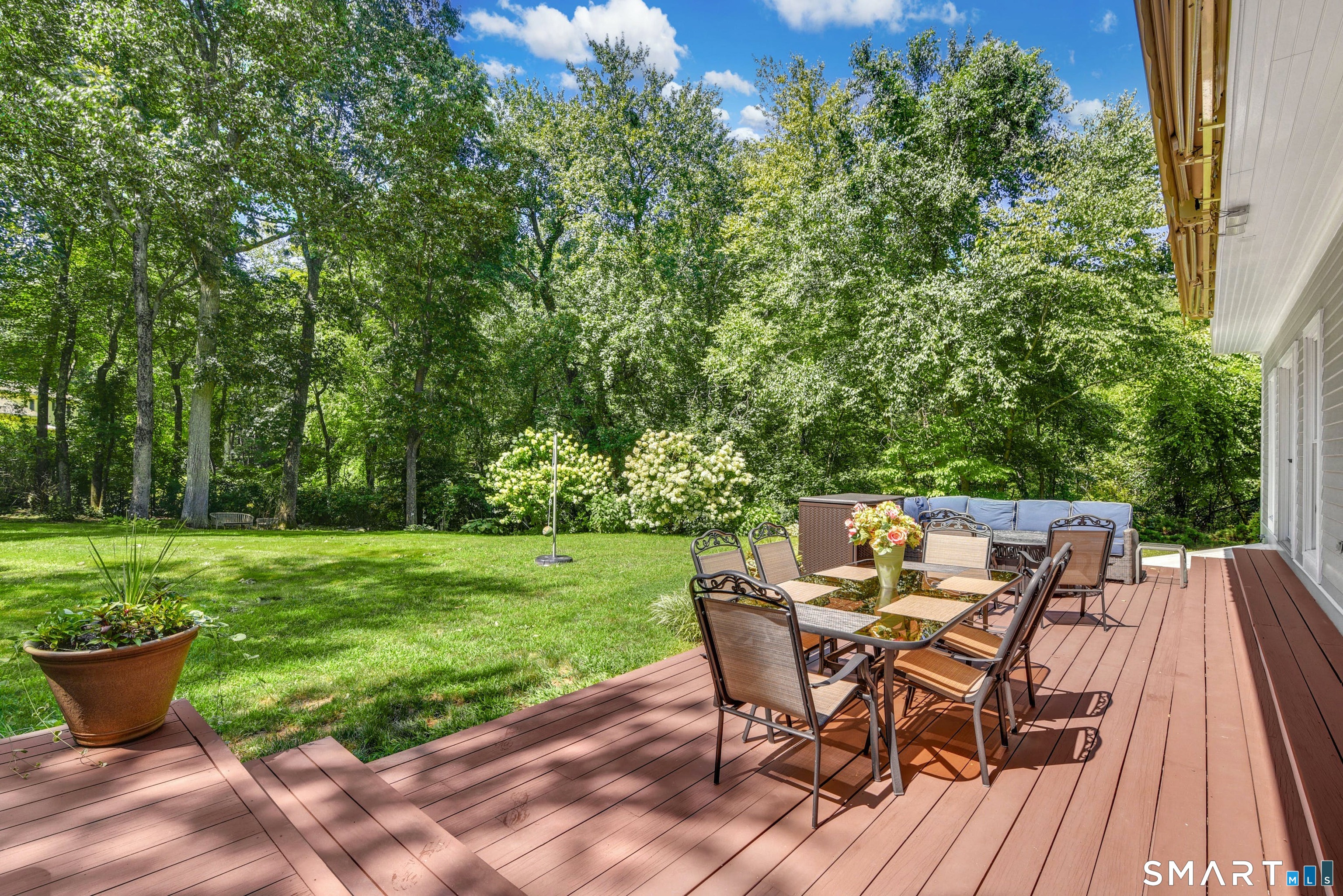 9 Pepperbush Road Weston, CT 06883 - Photo 8 of 48 a view of a backyard with table and chairs