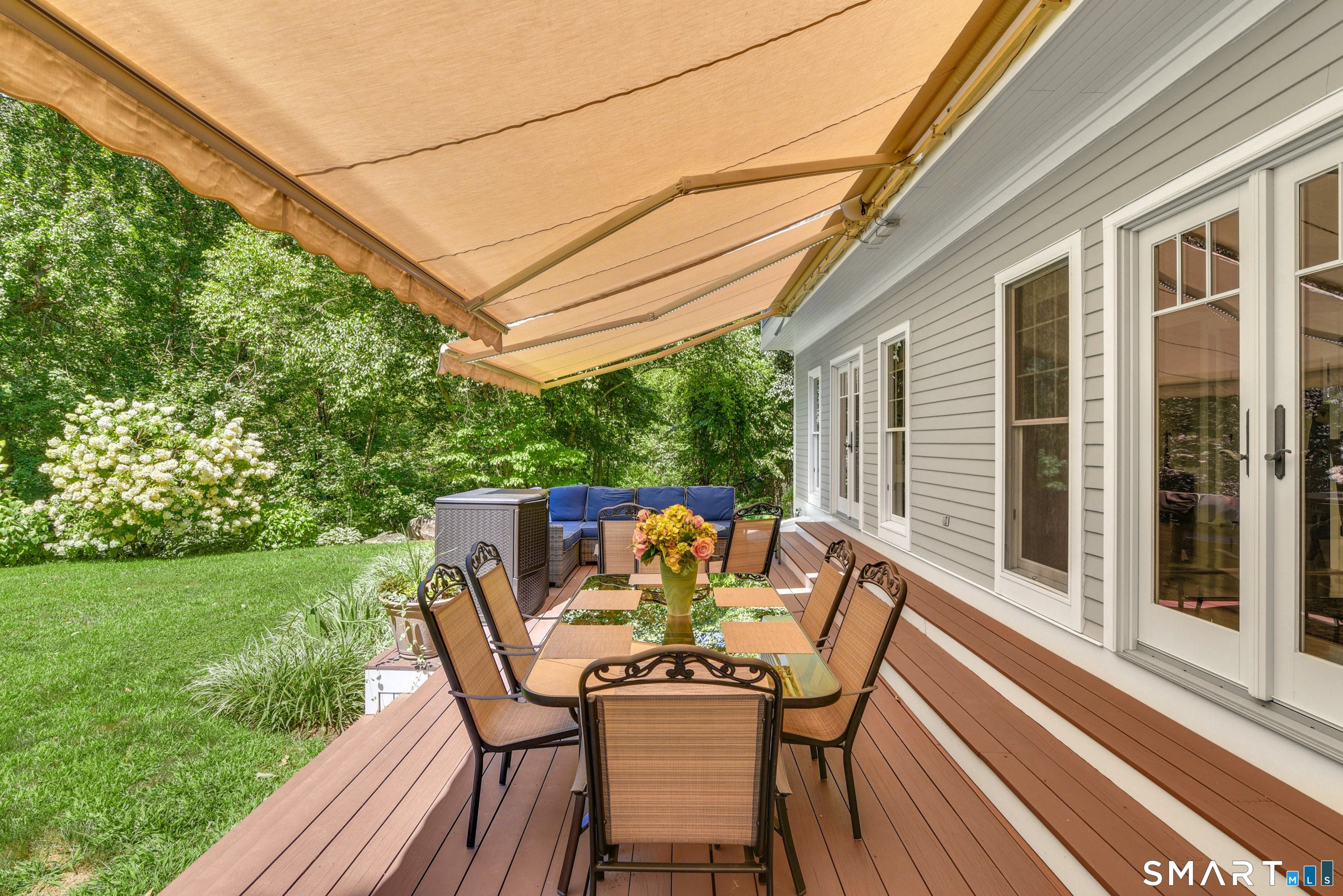 9 Pepperbush Road Weston, CT 06883 - Photo 9 of 48 a patio with wooden floor table and chairs