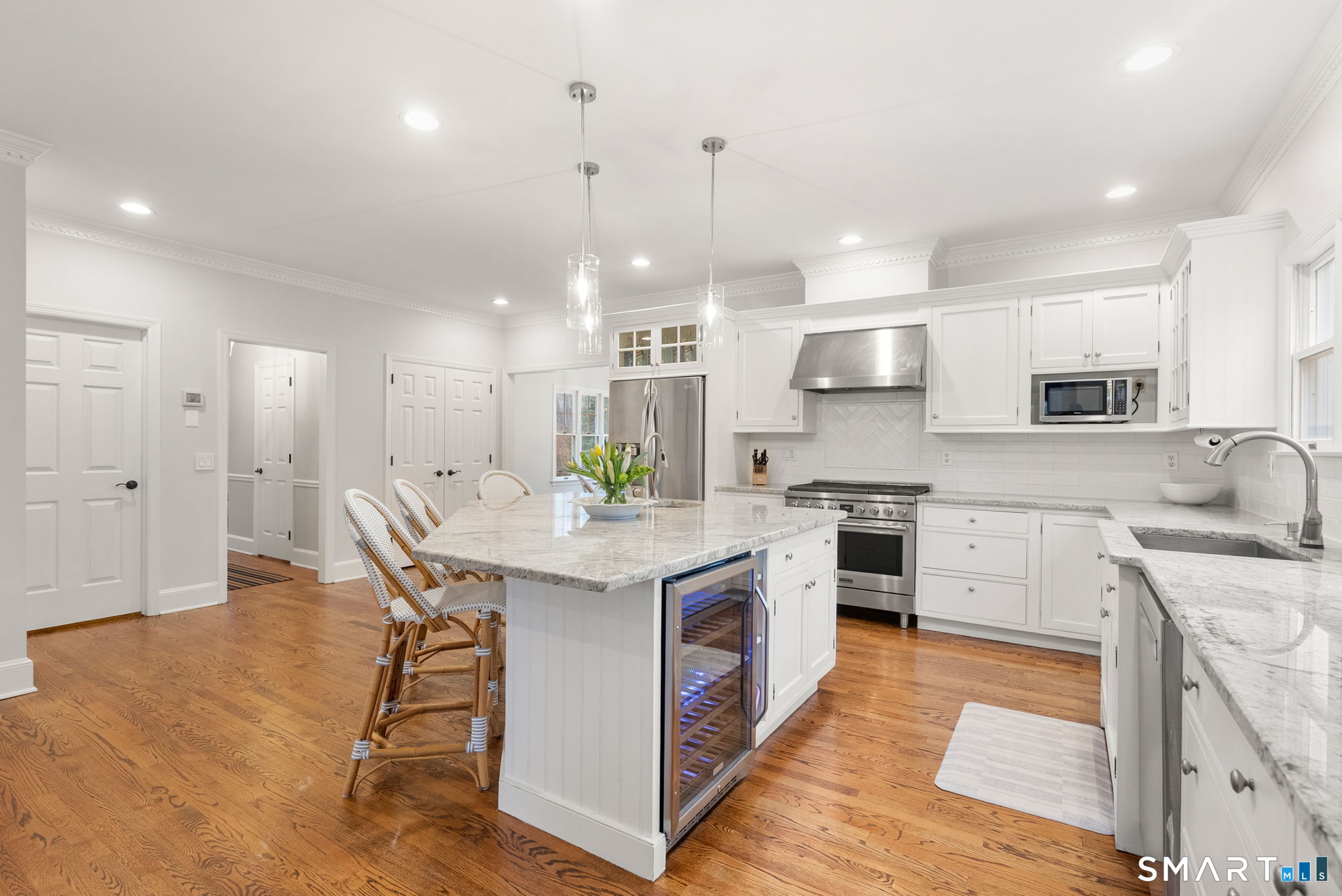 9 Pepperbush Road Weston, CT 06883 - Photo 10 of 48 a kitchen with a sink a center island stainless steel appliances and cabinets