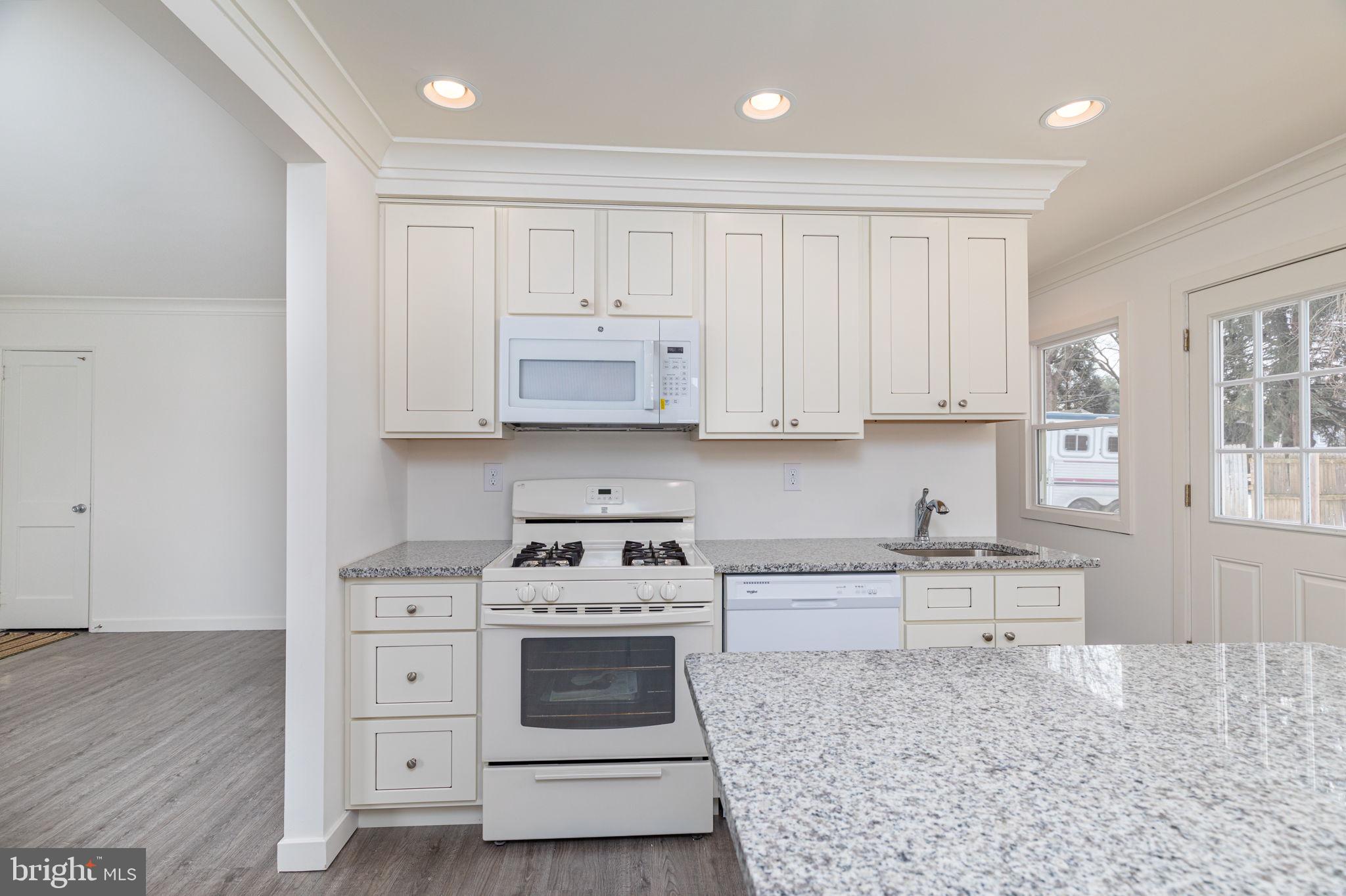 8 South Reed Street Bel Air, MD 21014 - Photo 3 of 21 a kitchen with stainless steel appliances granite countertop a stove a sink and a refrigerator