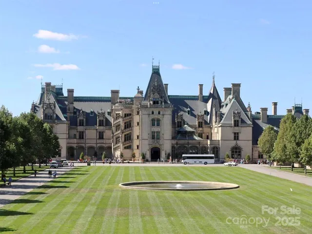 a aerial view of a big building with big yard plants and large trees