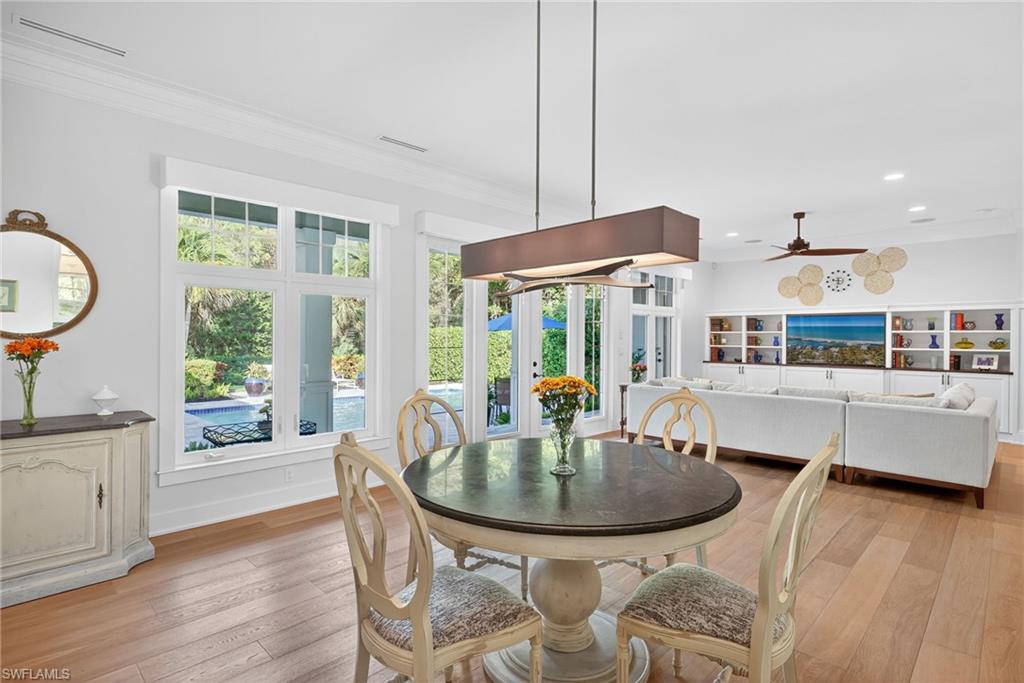 2305 Harrier Run Naples, FL 34105 - Photo 12 of 50 a kitchen with a table and chairs