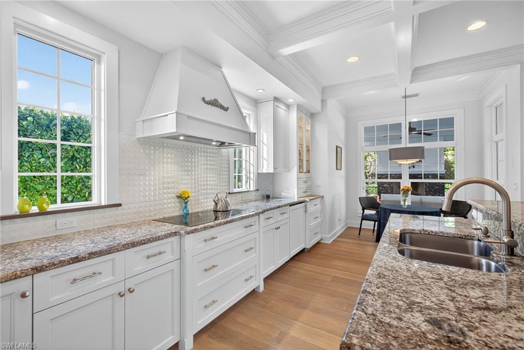 2305 Harrier Run Naples, FL 34105 - Photo 17 of 50 a kitchen with granite countertop a sink a counter space appliances and cabinets