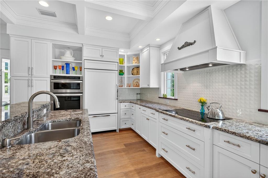2305 Harrier Run Naples, FL 34105 - Photo 18 of 50 a kitchen with stainless steel appliances granite countertop a sink stove and refrigerator