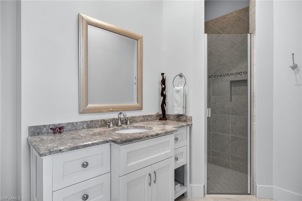 2305 Harrier Run Naples, FL 34105 - Photo 27 of 50 a bathroom with a granite countertop sink and a mirror