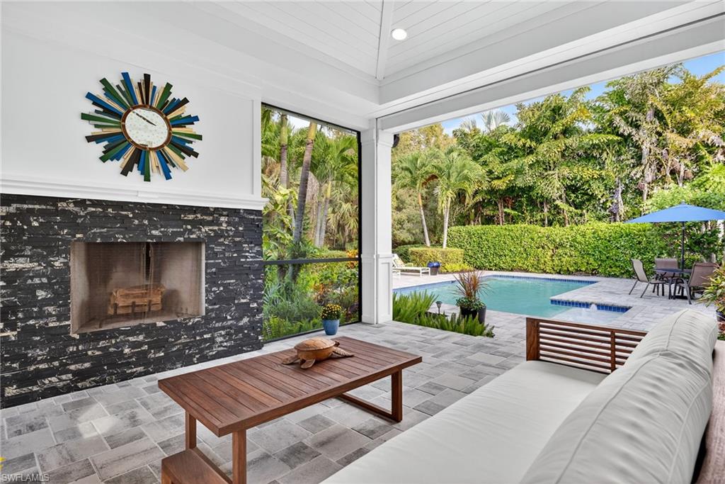 2305 Harrier Run Naples, FL 34105 - Photo 3 of 50 a outdoor living space with furniture and a fireplace