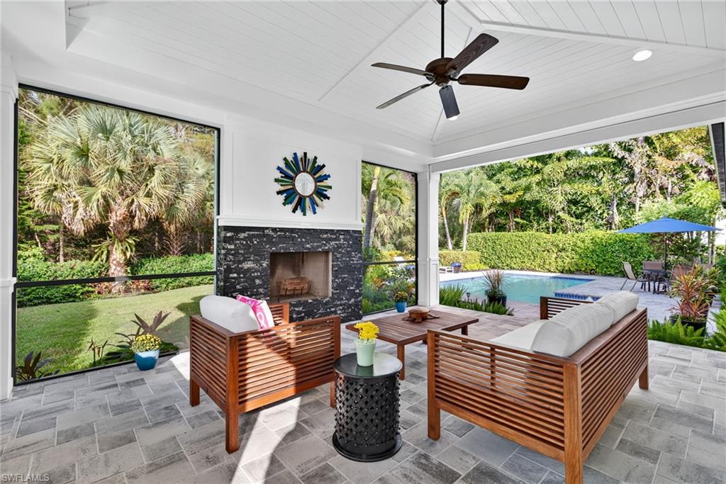2305 Harrier Run Naples, FL 34105 - Photo 37 of 50 a living room with furniture and a fireplace