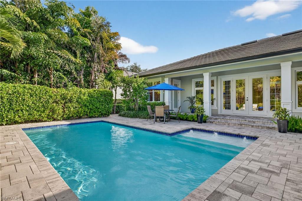 2305 Harrier Run Naples, FL 34105 - Photo 40 of 50 a view of a house with swimming pool and sitting area
