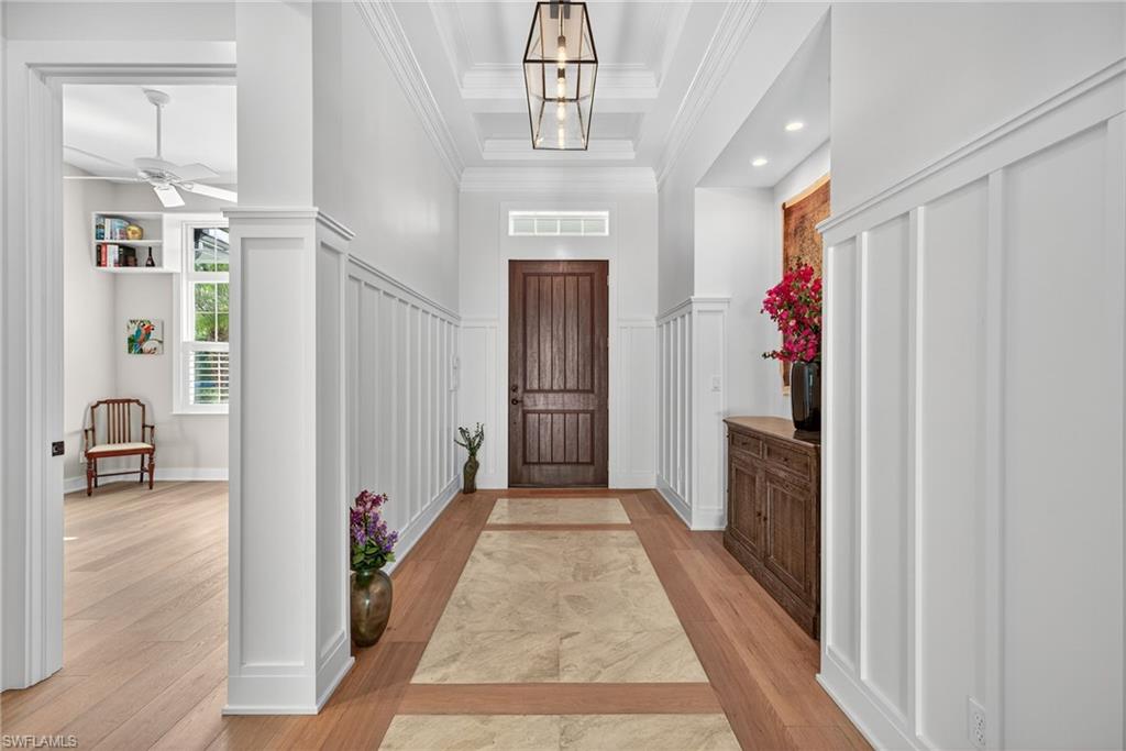 2305 Harrier Run Naples, FL 34105 - Photo 4 of 50 a view of hallway with wooden floor and stairs