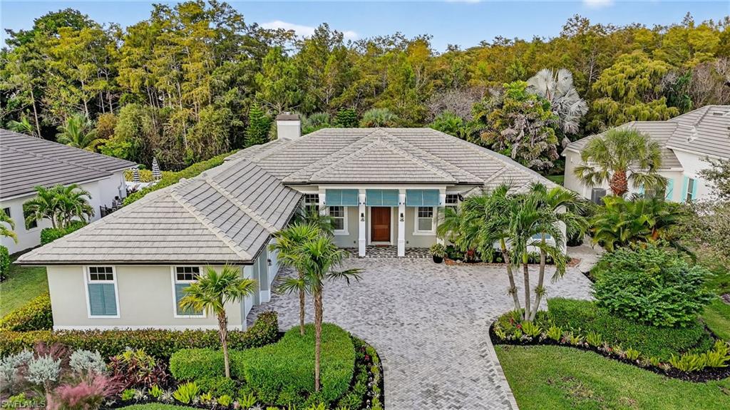 2305 Harrier Run Naples, FL 34105 - Photo 43 of 50 a view of a house with a yard and potted plants