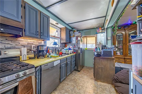 a kitchen with lots of counter top space and wooden floor