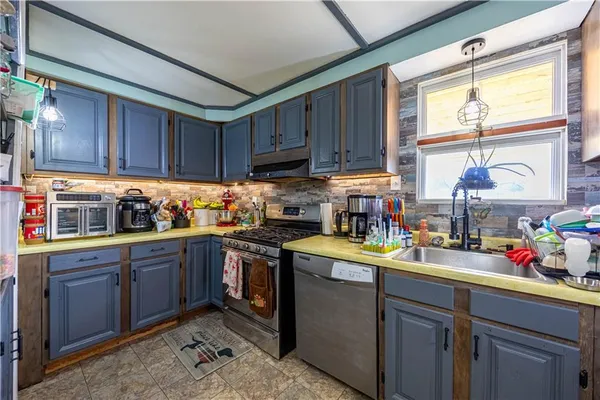 a kitchen with a sink window and cabinets