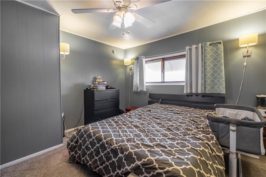 751 Sixth Street Pitcairn, PA 15140 - Photo 7 of 13 a bedroom with a bed and a chandelier