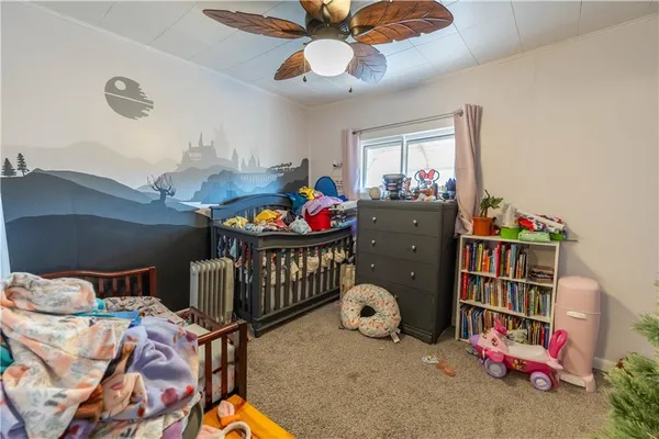 a bedroom with furniture and a baby crib