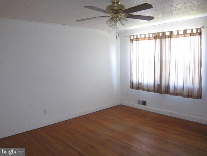 8540 Water Oak Road Baltimore, MD 21234 - Photo 2 of 12 an empty room with a empty space and windows