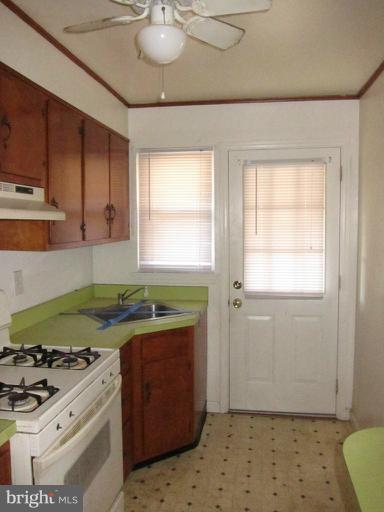 8540 Water Oak Road Baltimore, MD 21234 - Photo 5 of 12 a kitchen with a stove a sink and a refrigerator