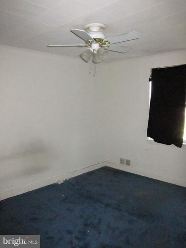 8540 Water Oak Road Baltimore, MD 21234 - Photo 8 of 12 an empty room with a ceiling fan and wooden floor