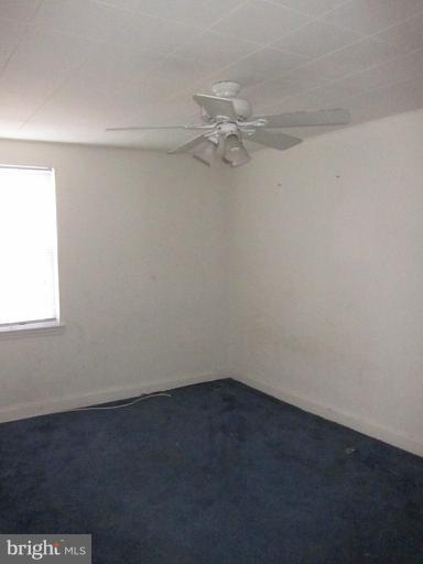 8540 Water Oak Road Baltimore, MD 21234 - Photo 9 of 12 an empty room with a fan and a window
