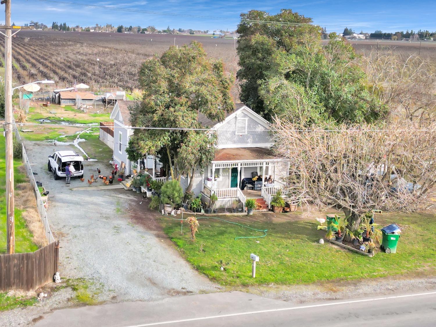 20388 Highway 99 Acampo, CA 95220 - Photo 15 of 24 a front view of a house with garden and houses