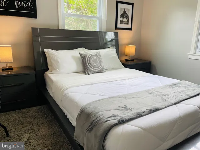 a bedroom with a bed and window