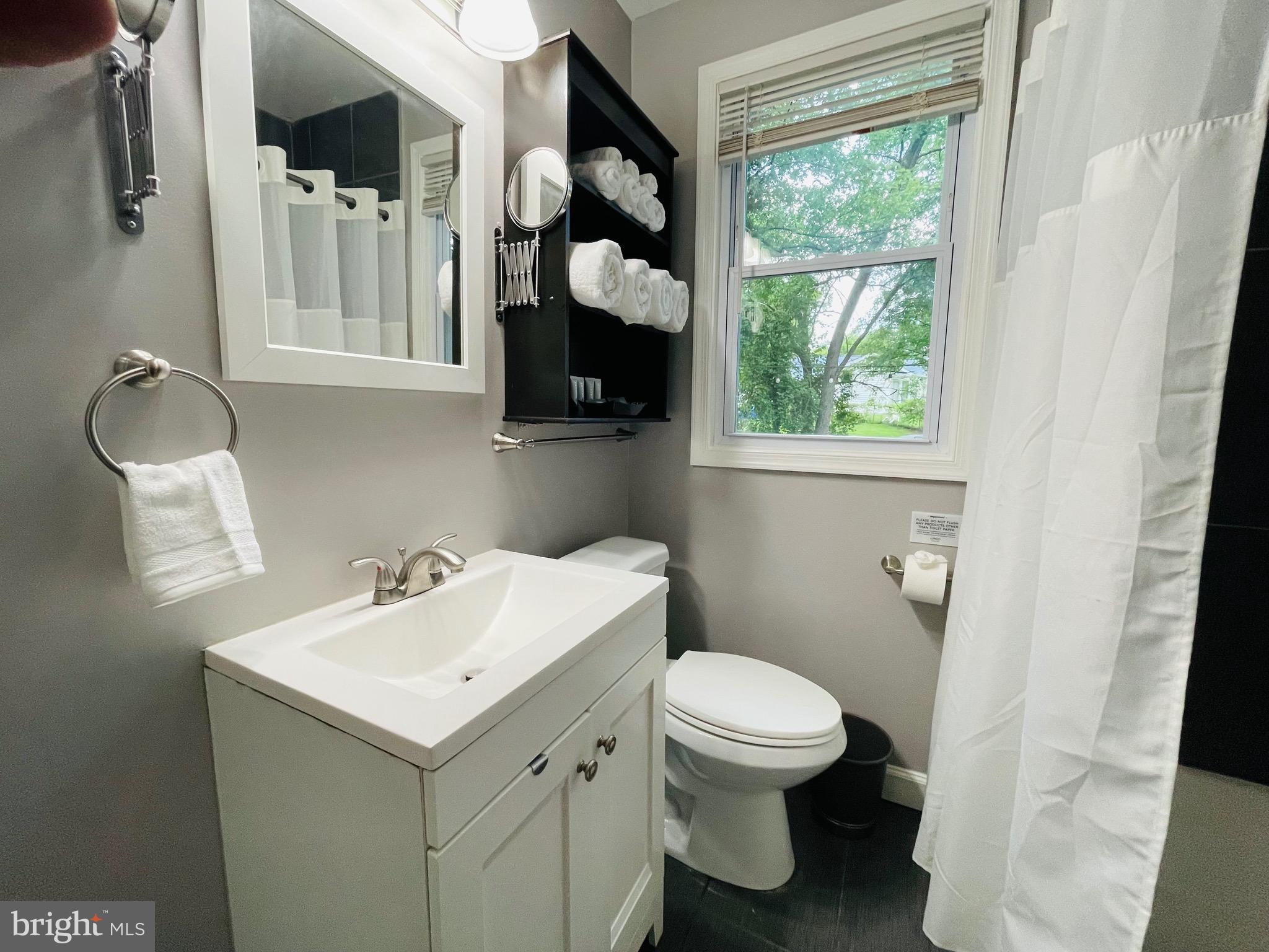 2723 Randolph Road Silver Spring, MD 20902 - Photo 17 of 33 a bathroom with a toilet sink and mirror