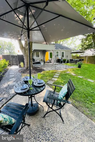 a view of a swimming pool with chair and table in the patio