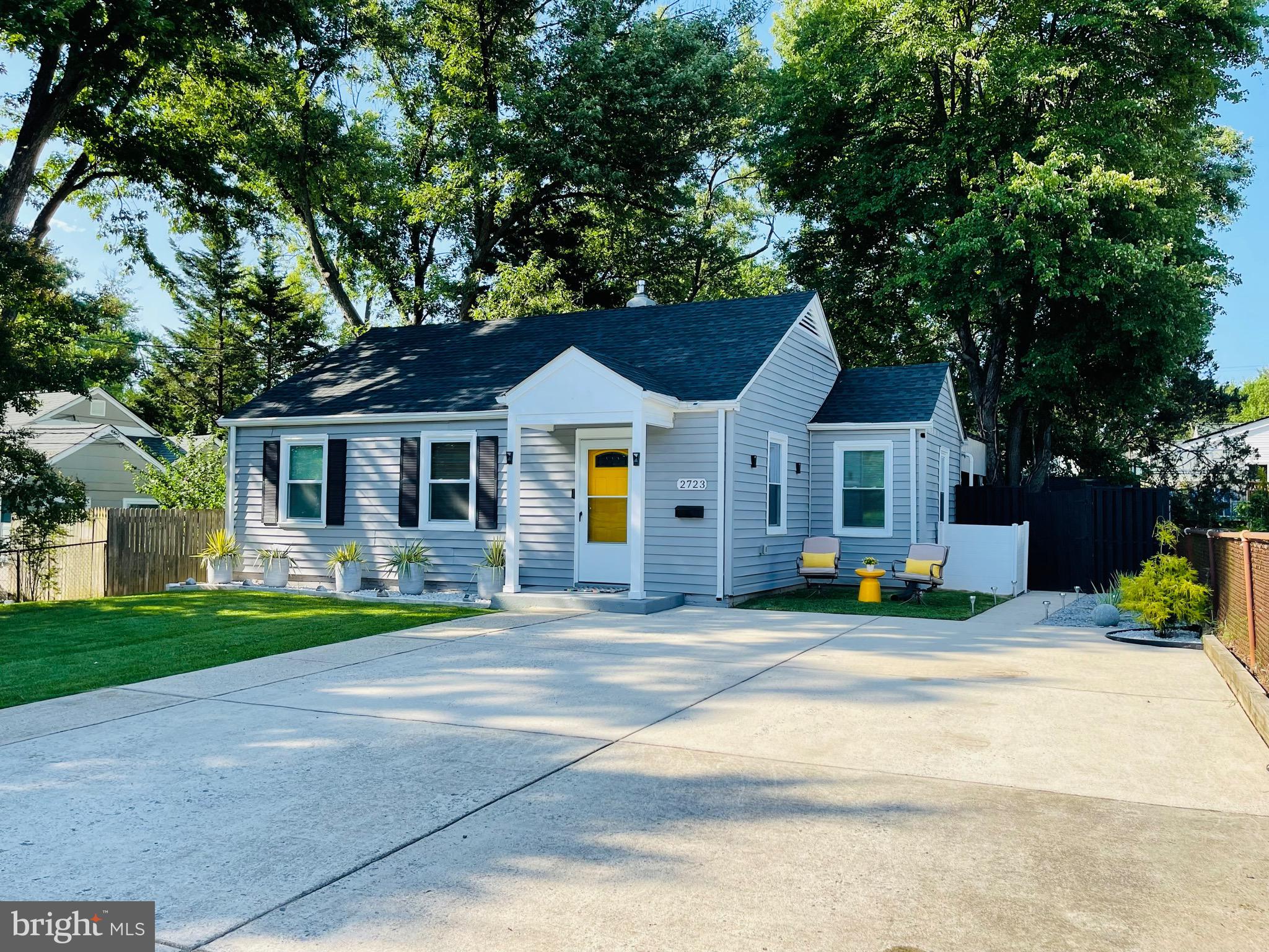 2723 Randolph Road Silver Spring, MD 20902 - Photo 2 of 33 a front view of a house with a garden and tree