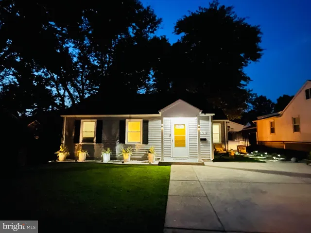 a front view of a house with a garden and yard