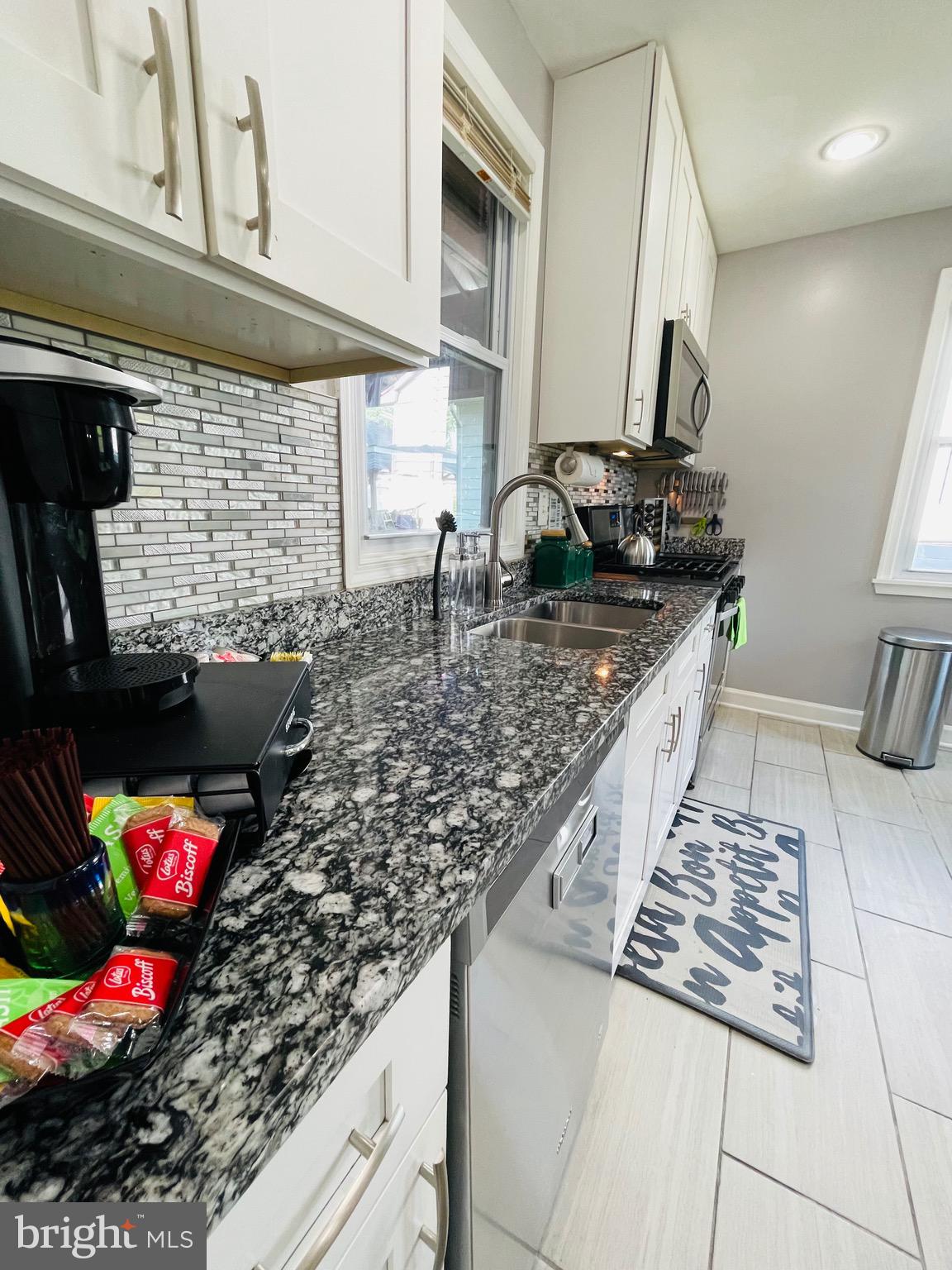 2723 Randolph Road Silver Spring, MD 20902 - Photo 9 of 33 a kitchen with stainless steel appliances granite countertop a sink stove and cabinets