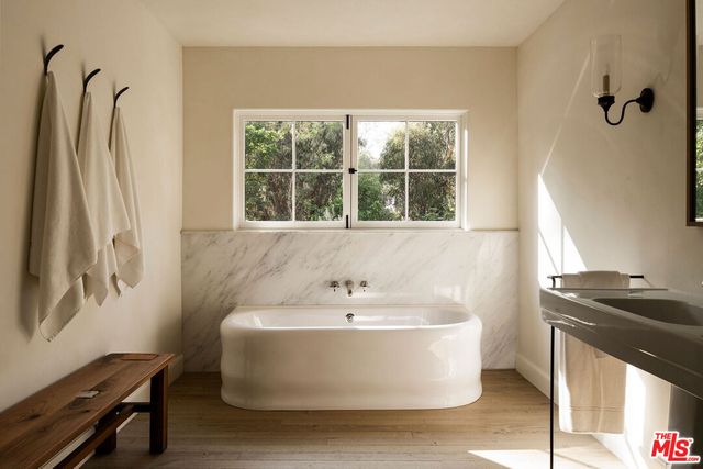 a white bath tub sitting next to a window