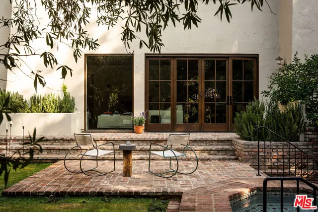 a view of a house with backyard porch and sitting area